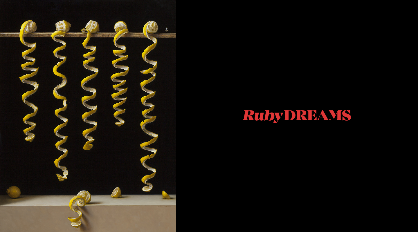Six curled lemon peels hang from a rod against a dark background; to the right, “RubyDREAMS” is written in red text on a black background.
